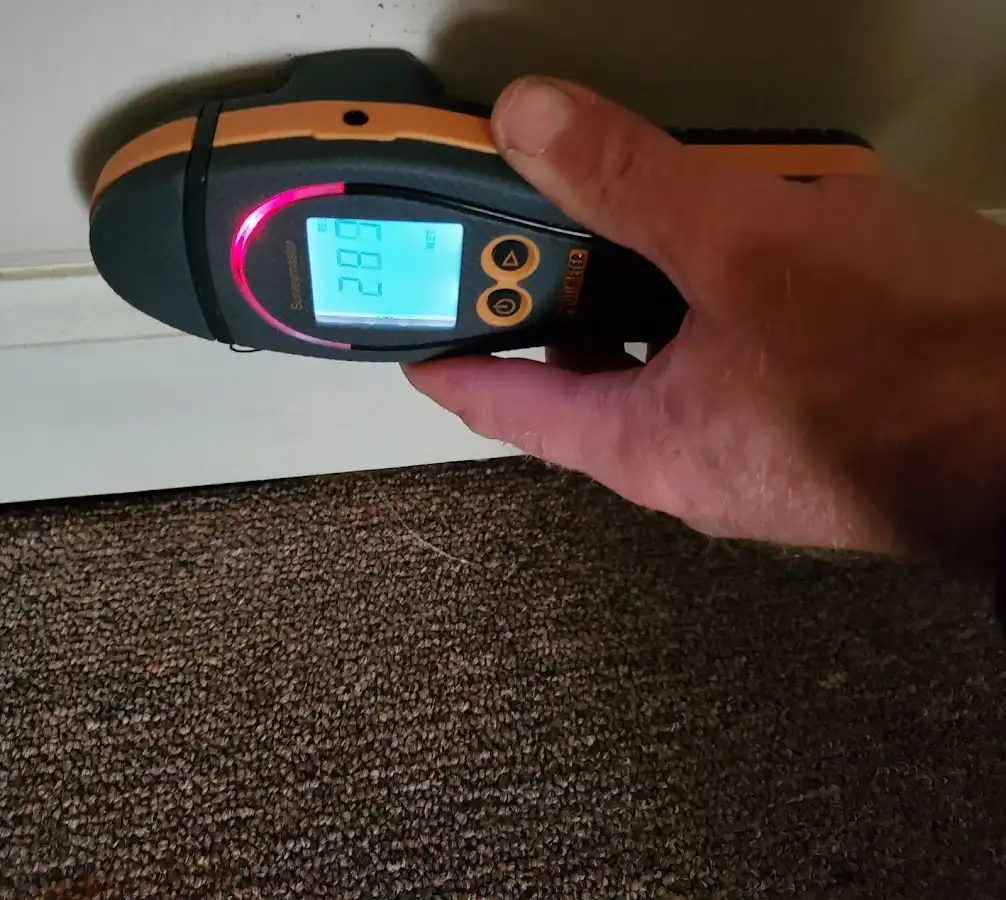 Moisture detection at baseboard during Storm Damage Restoration in Cairo